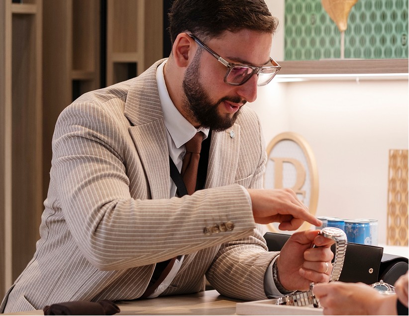 Parmigiani Fleurier boutique advisor presenting a timepiece to a client