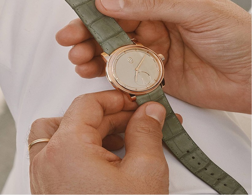 Close-up of hands adjusting a Parmigiani Fleurier timepiece strap